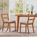 Set of two brown farmhouse wooden dining chairs with upholstered linen seats and slat backrests