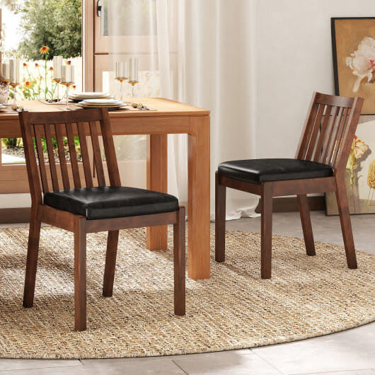 Two espresso PU leather upholstered dining chairs with natural rubber wood frames and slatted backrests.