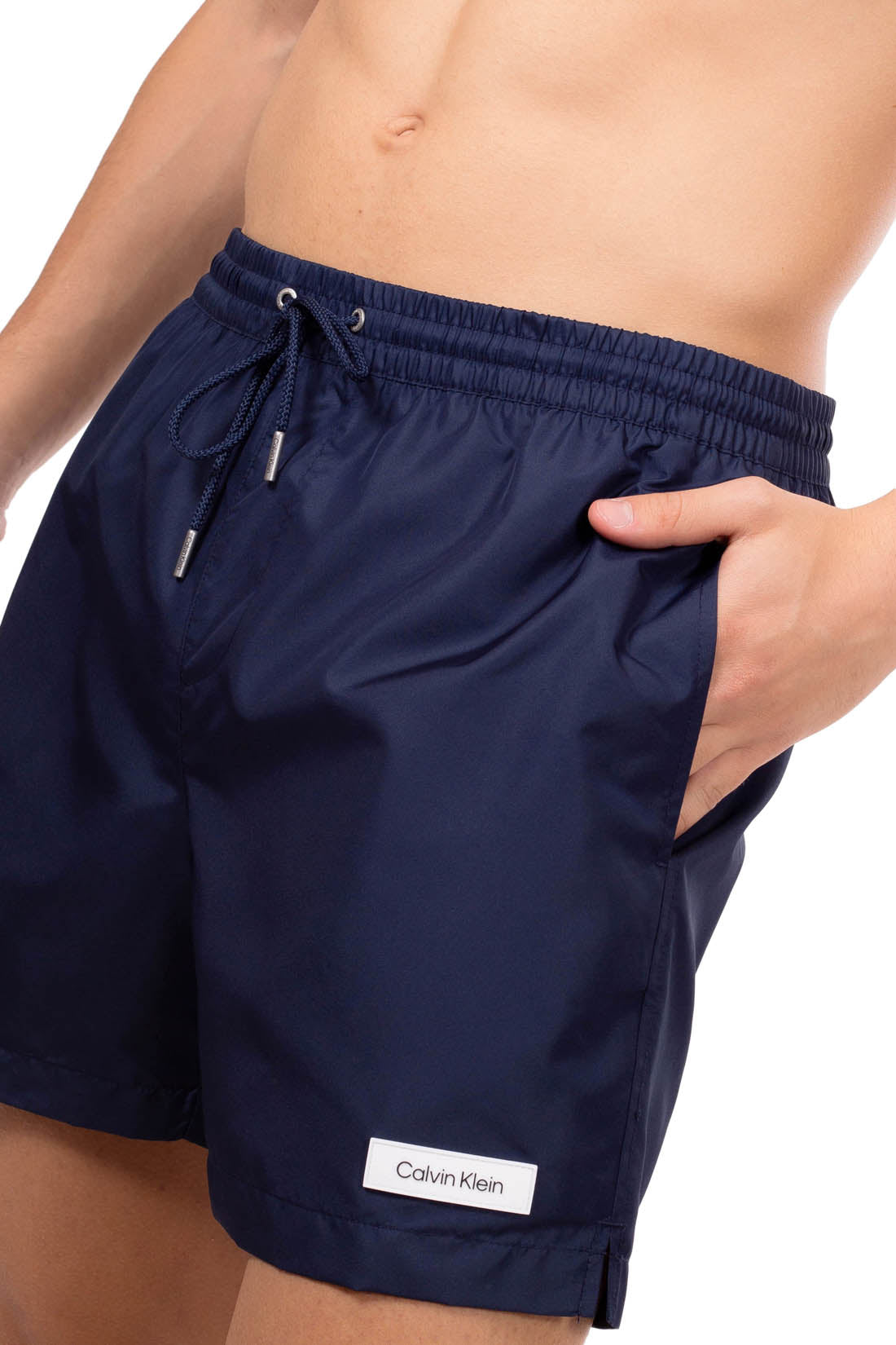 Blue Calvin Klein men's swim shorts with elastic waistband, drawstring, and white patch logo. — view 9