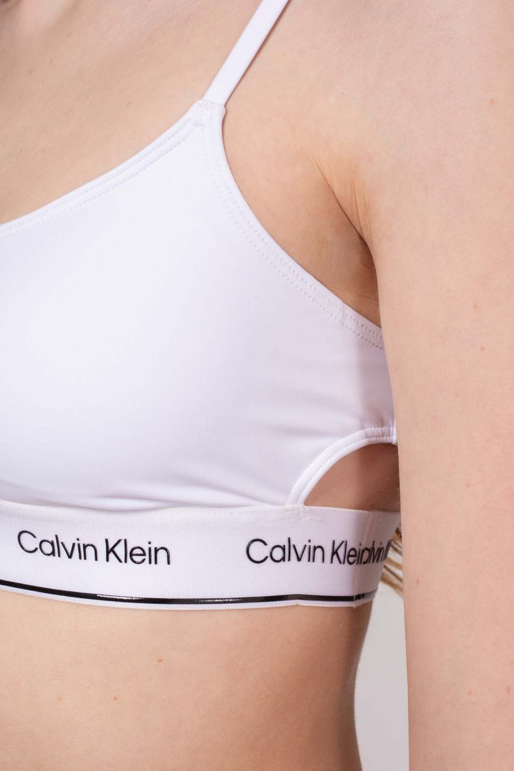 White bandeau bikini top with side cut-outs, adjustable straps, and printed contrasting logo underbust band — view 25