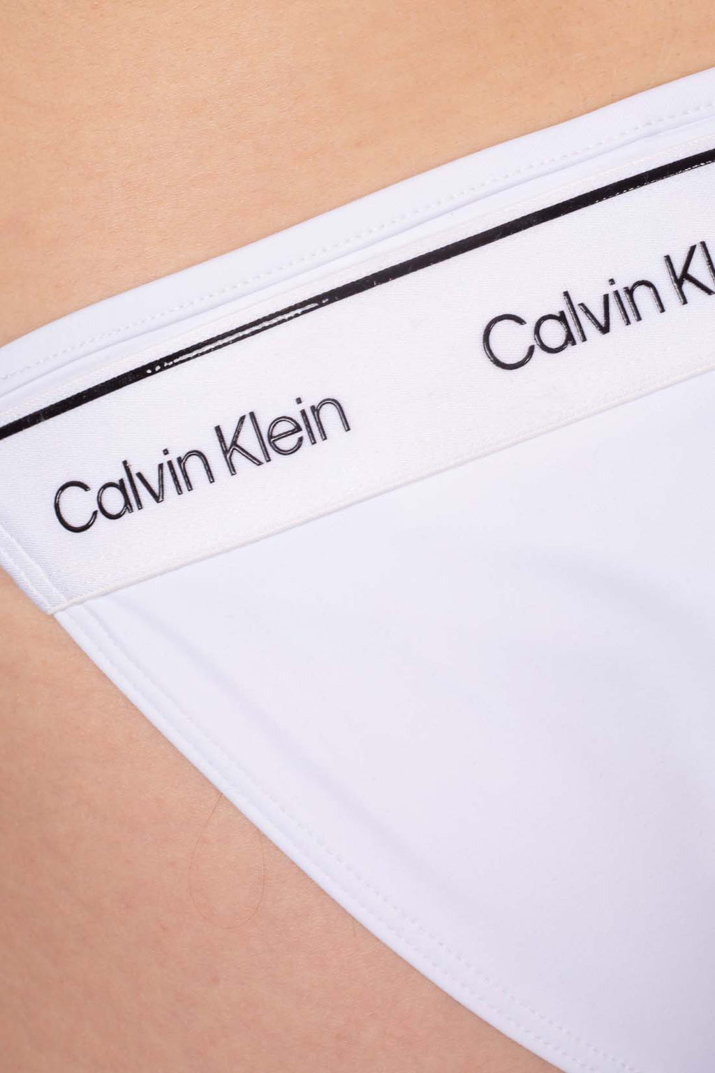 White stretch nylon bikini brief with side tie laces and signature Calvin Klein logo detail — view 25