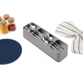 Gray plastic kitchen drawer organizer tray with compartments for cutlery, knives, and spice bottles