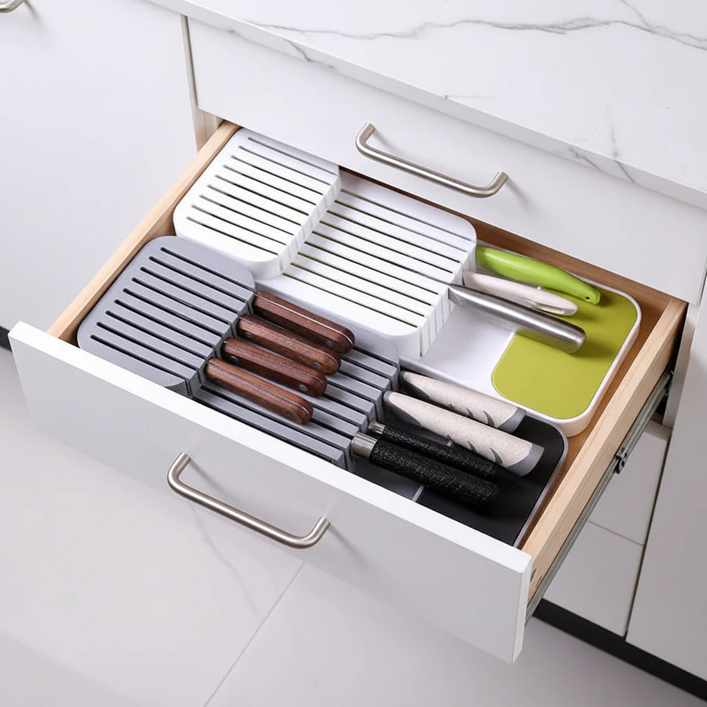 Gray plastic kitchen drawer organizer tray with compartments for cutlery, knives, and spice bottles — view 5