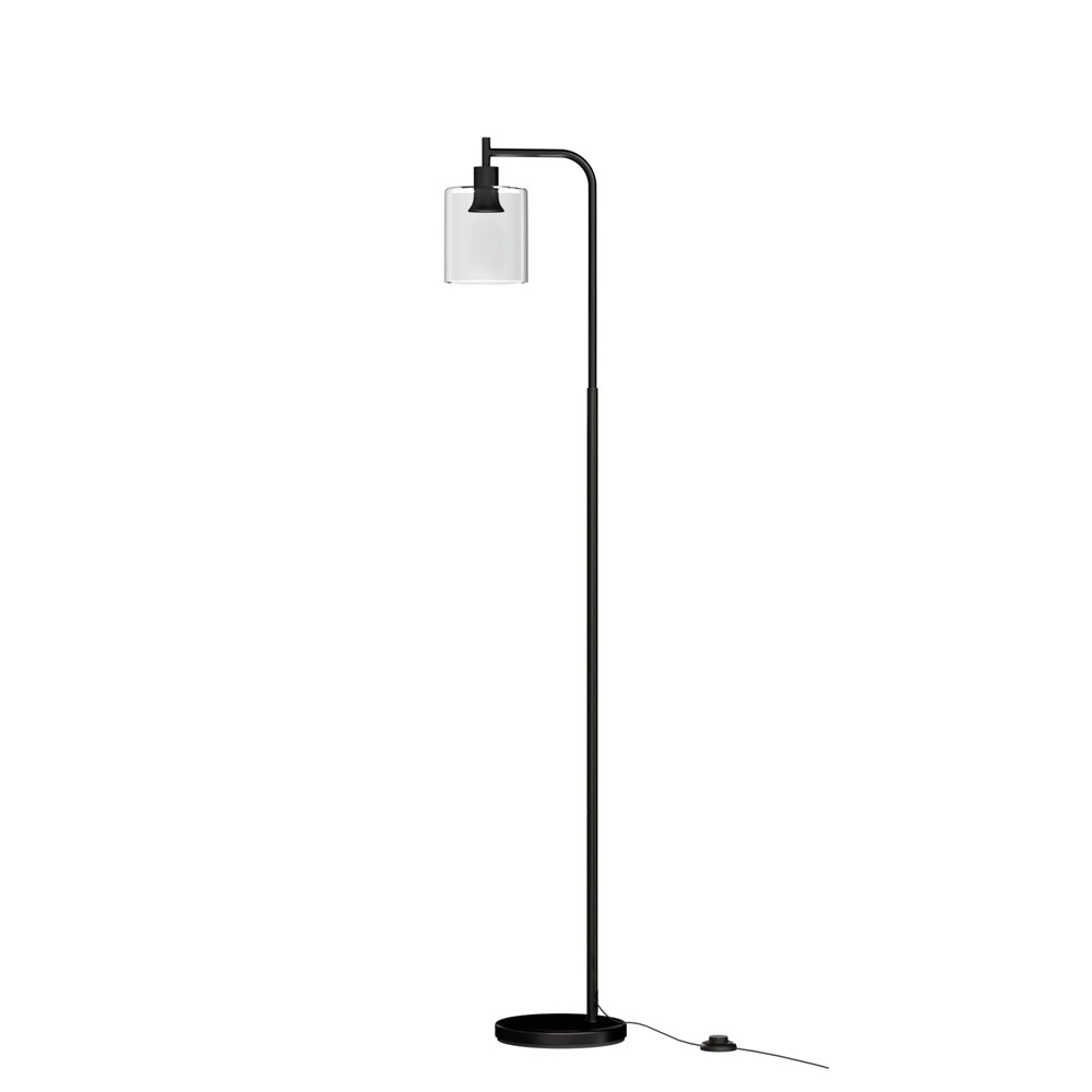 Modern black metal floor lamp with glass shade illuminating a stylish living room setting