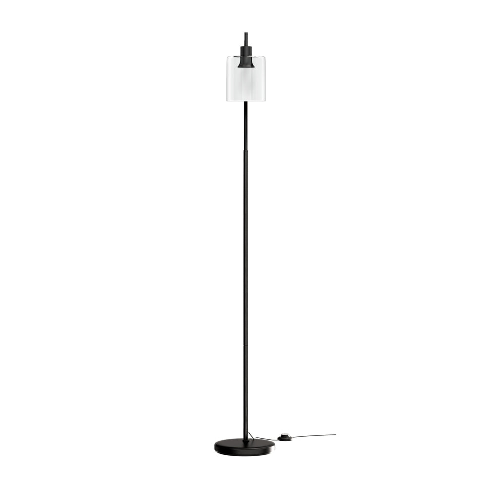 Modern black metal floor lamp with glass shade illuminating a stylish living room setting — view 3