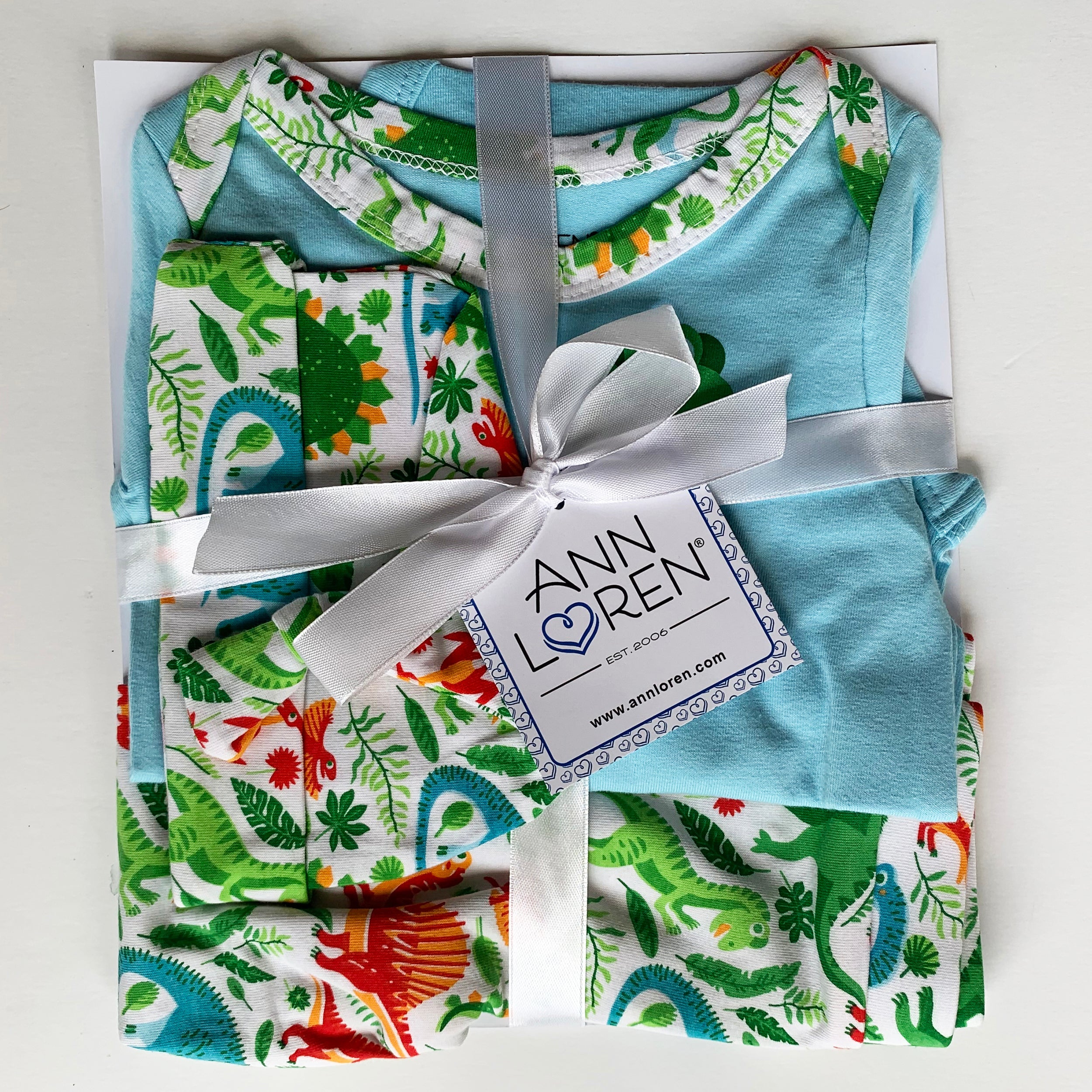 3-piece dinosaur baby layette set with green and white bodysuit, jogger pants, and cap — view 2