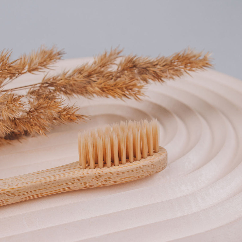 Set of four natural bamboo toothbrushes with soft bristles in zero waste kraft paper packaging — view 5