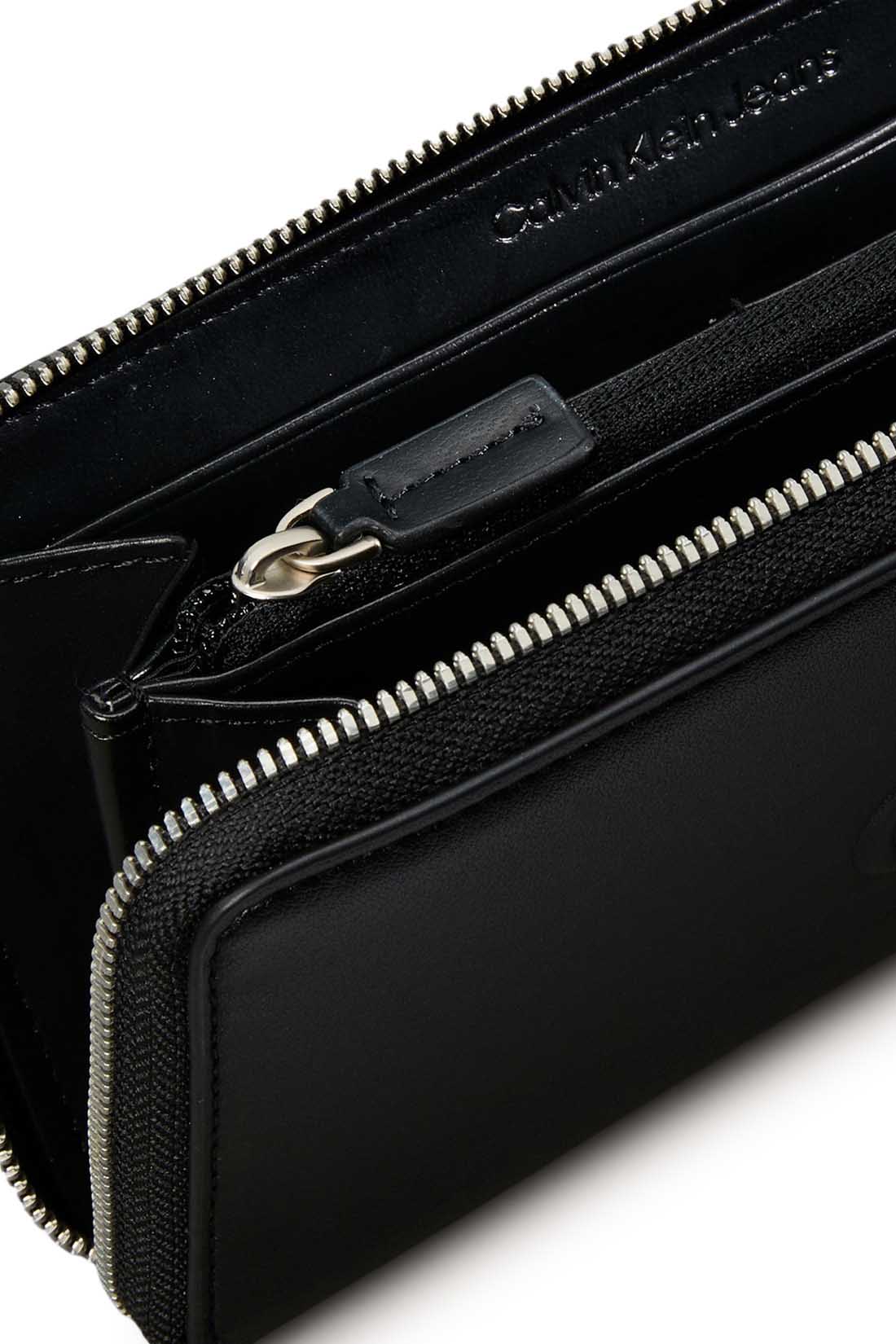 Smooth black women's faux leather zip-around wallet with embossed monogram and logo hardware — view 6