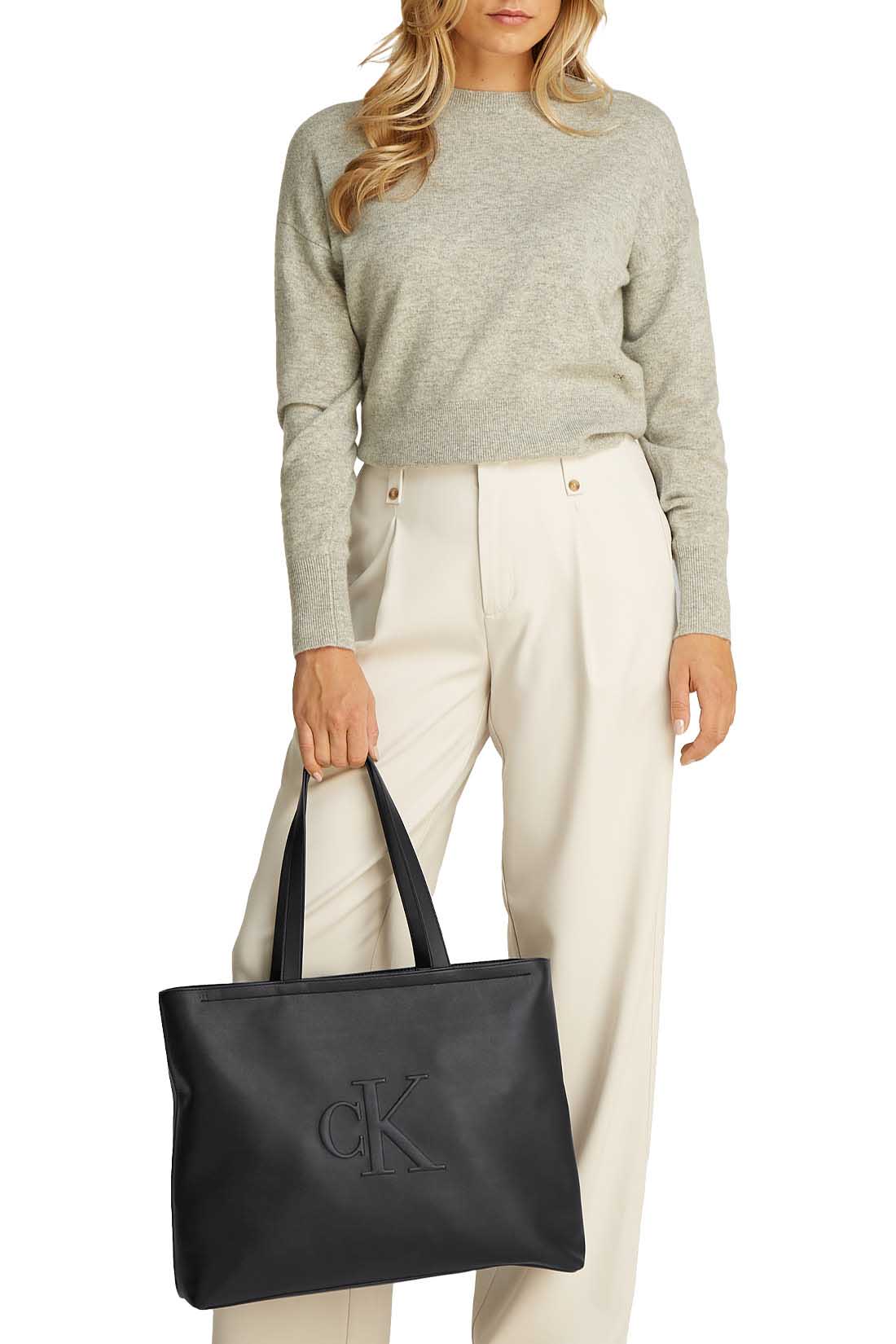 Womens black faux-leather tote bag with double handles and embossed monogram front detailing — view 14
