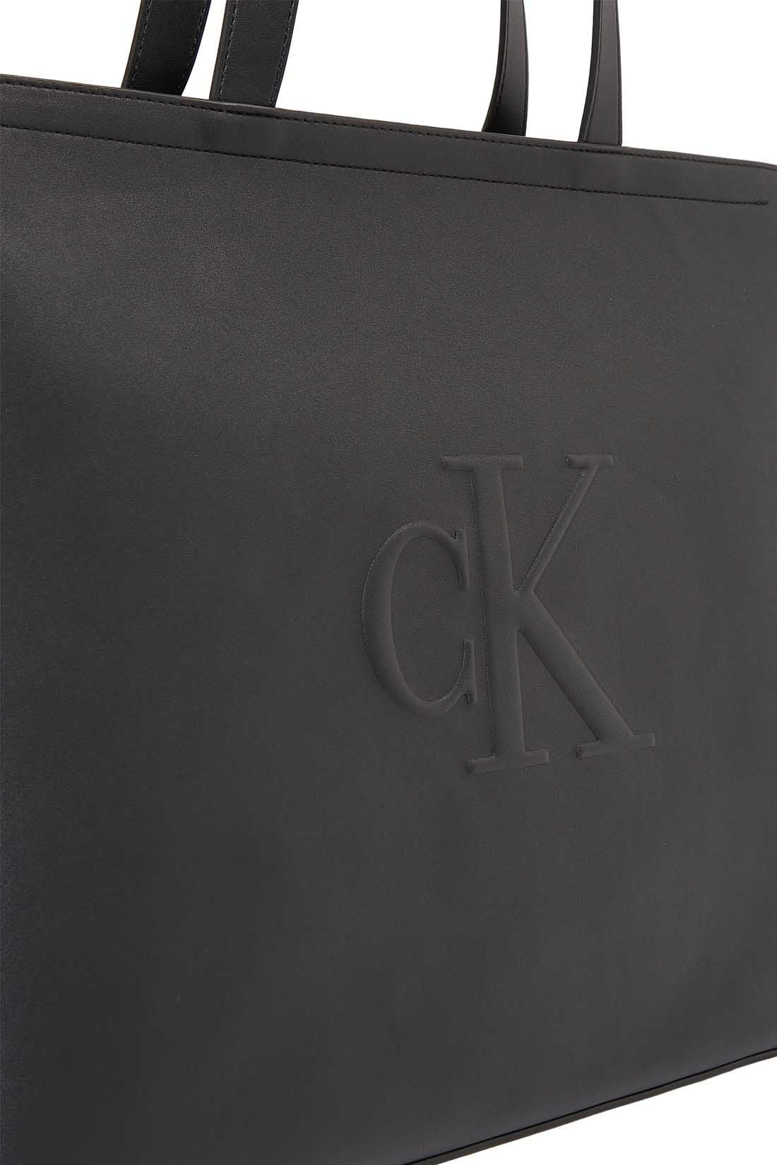 Womens black faux-leather tote bag with double handles and embossed monogram front detailing — view 12