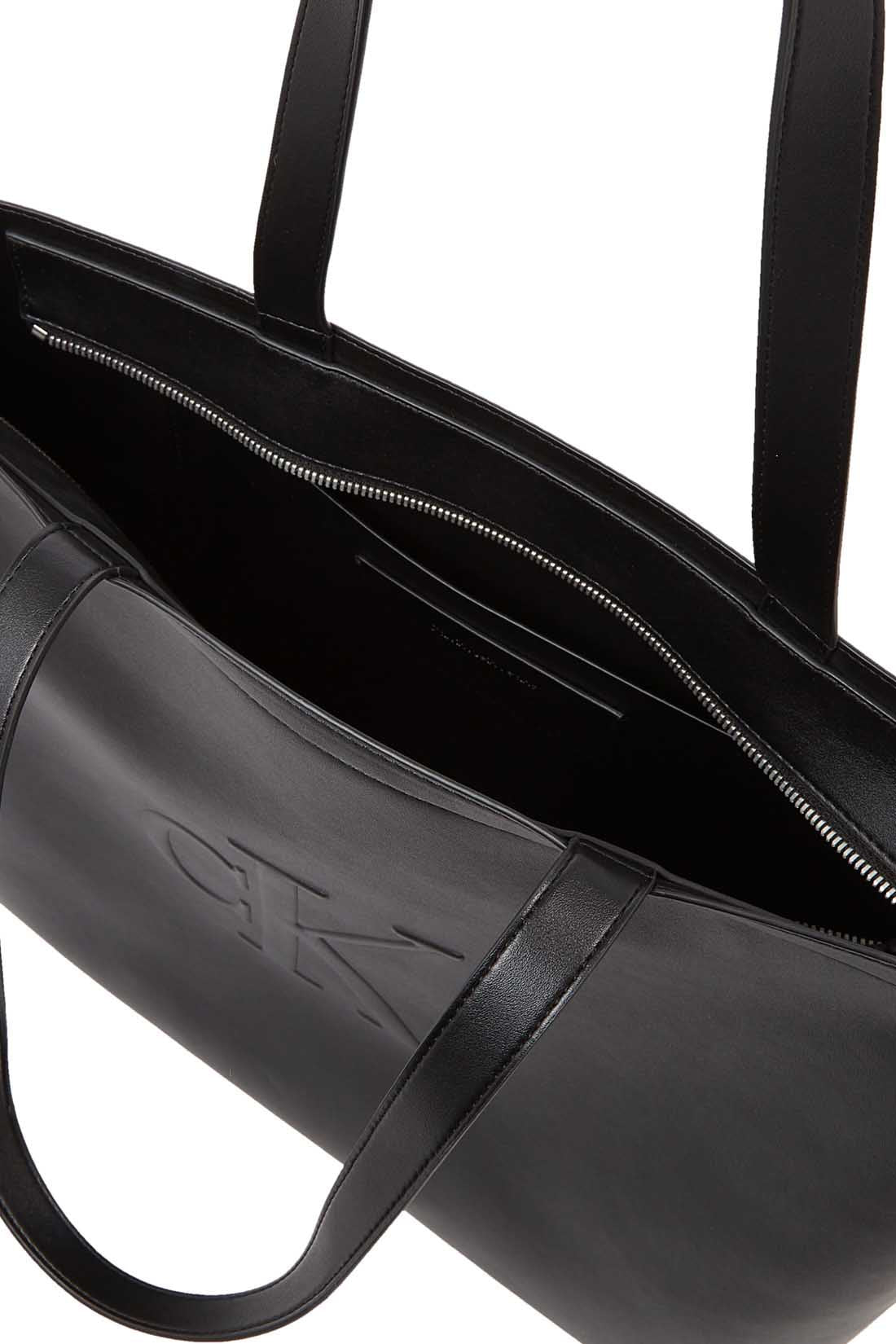 Womens black faux-leather tote bag with double handles and embossed monogram front detailing — view 11