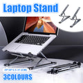 Foldable silver aluminum laptop stand with adjustable height structure and protective carrying bag.
