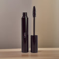 Black lengthening mascara tube and applicator brush with creamy smudge-proof vegan makeup formula