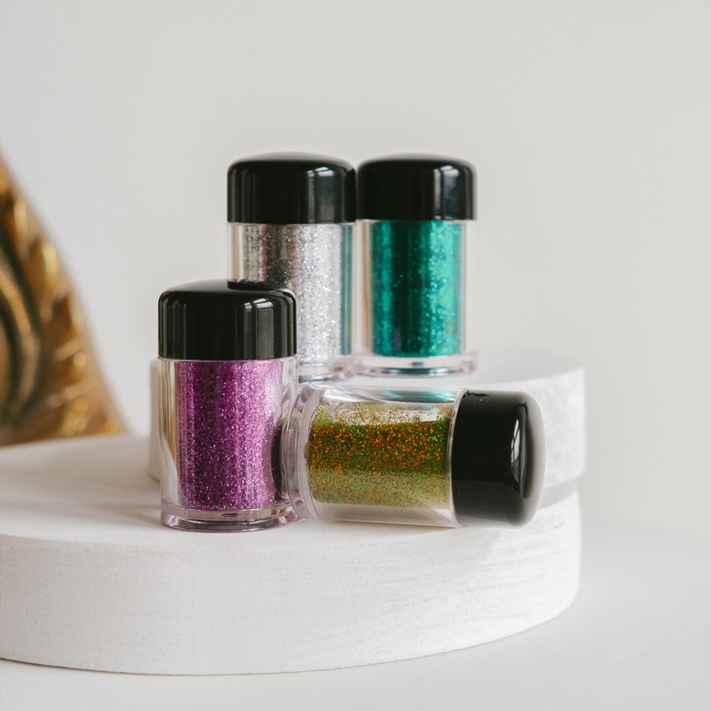 Aquamarine blue ultra-fine loose glitter eyeshadow dust in a small clear makeup jar — view 5