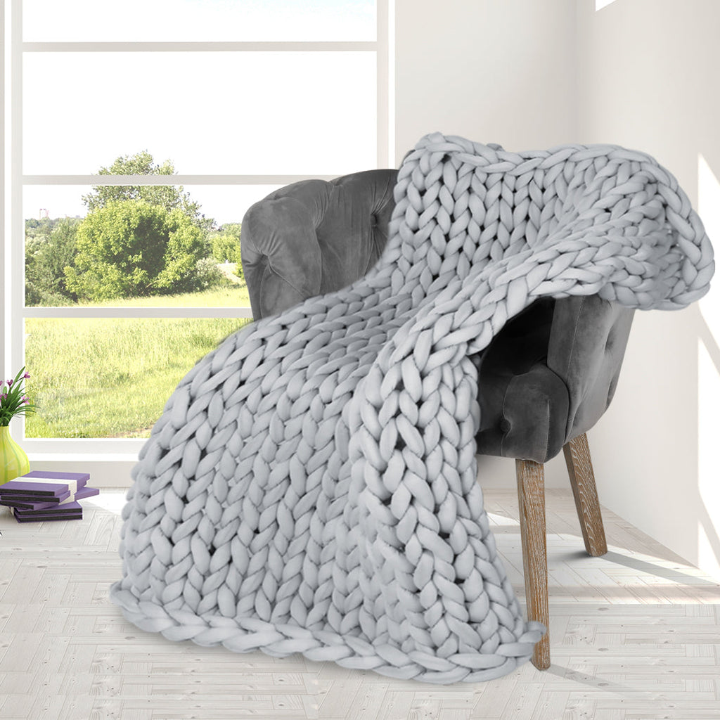 Chunky grey knitted weighted blanket folded neatly on a bed for anxiety relief and restful sleep — view 5