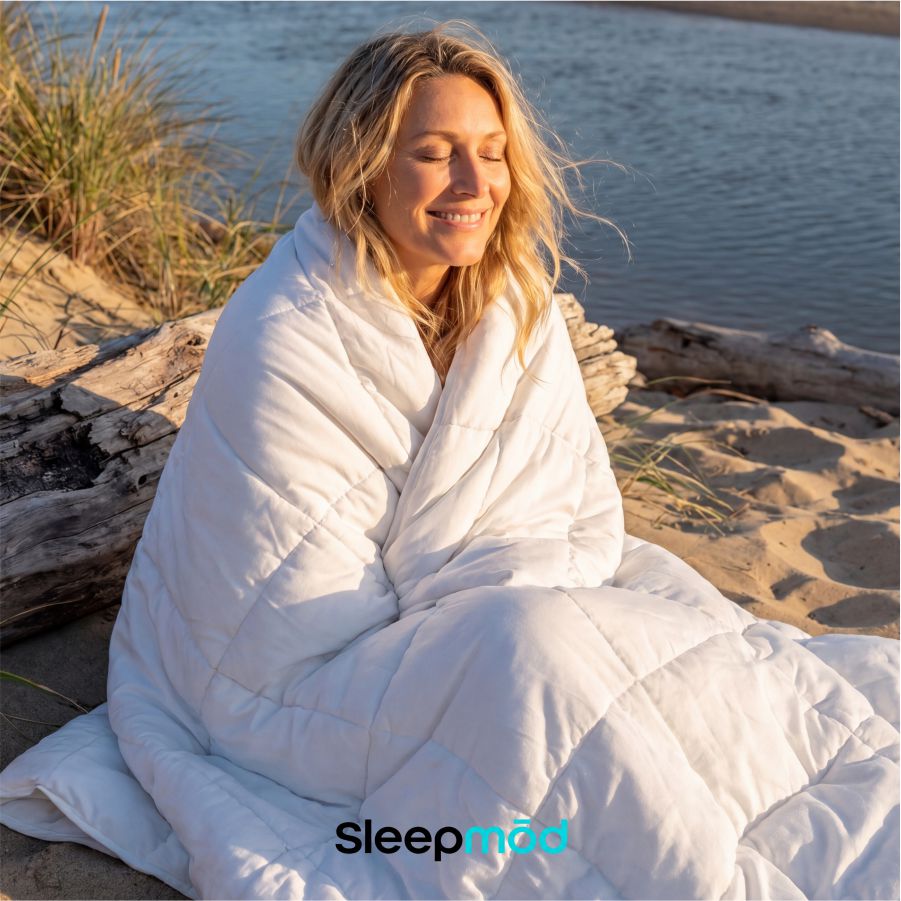 White eucalyptus silk cooling comforter and two matching quilted pillow shams neatly arranged on bed — view 4