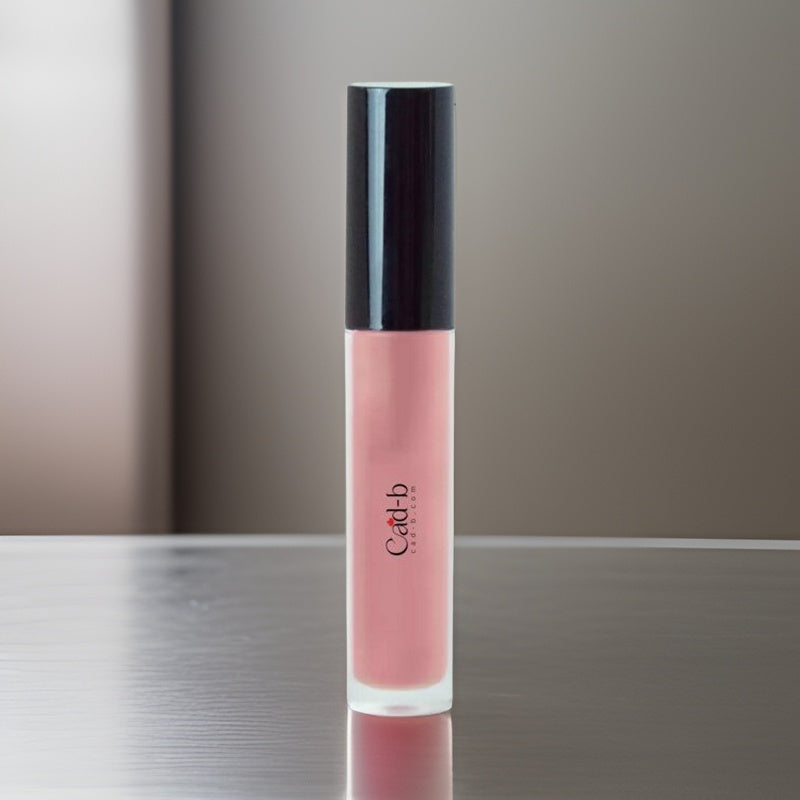 Tropical coral pink lip gloss tube with doe foot applicator and luminous sheer shimmer.