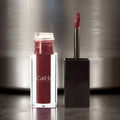 Vegan liquid cream lipstick tube with applicator, showing rich full-coverage color and velvet finish.