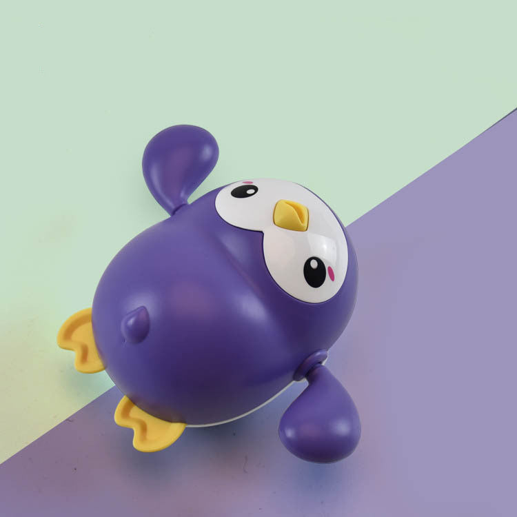 Little penguin wind-up bath toy for toddlers in bright colors floating on water — view 2