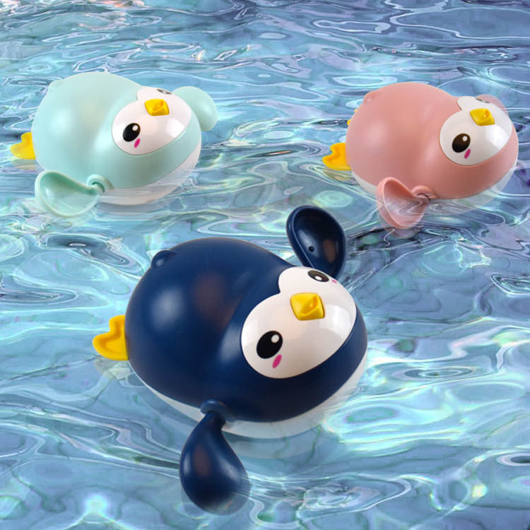 Little penguin wind-up bath toy for toddlers in bright colors floating on water — view 3