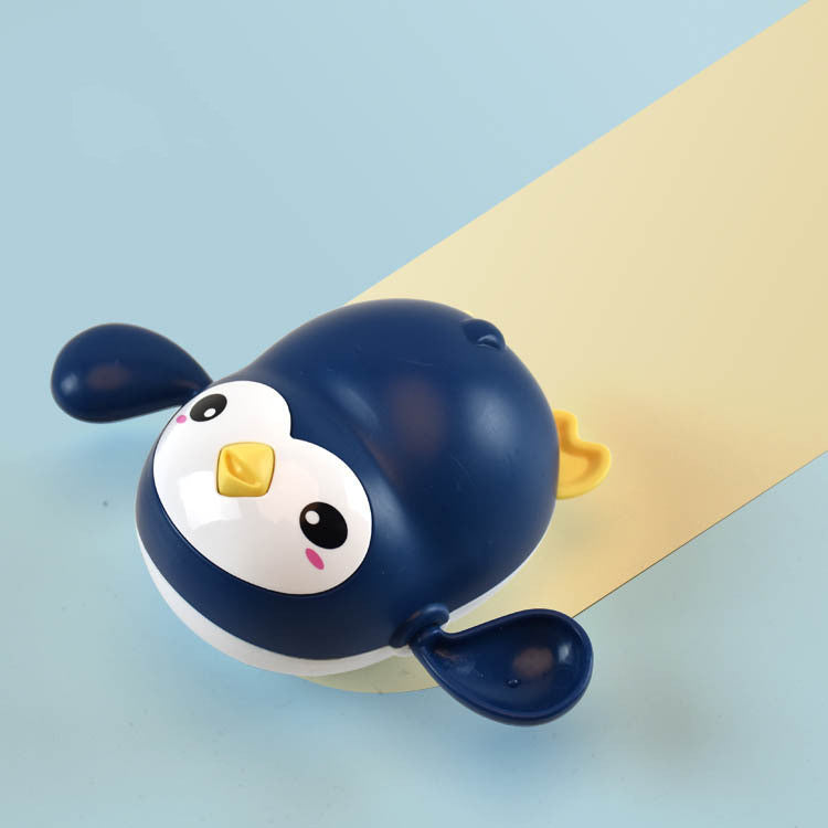 Little penguin wind-up bath toy for toddlers in bright colors floating on water — view 4