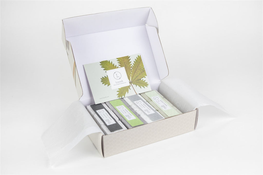 Set of 12 earthy shower steamers in a premium gift box with natural botanical tops