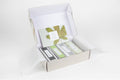 Set of 12 earthy shower steamers in a premium gift box with natural botanical tops