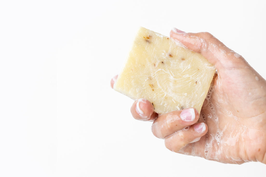 Two natural handmade lavender soap bars with real buds packed in a reusable cotton bag. — view 3