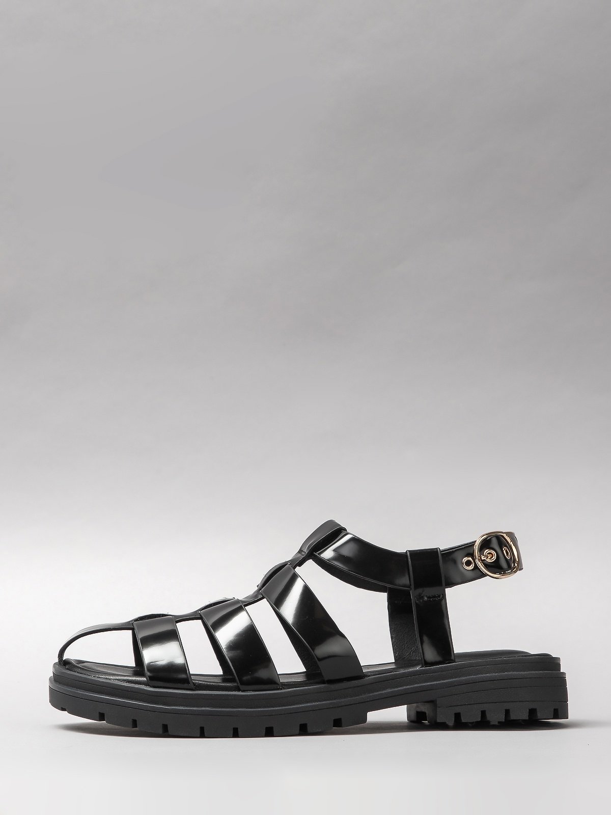 Pair of black women's sandals featuring minimalist synthetic straps and a comfortable flat walking sole