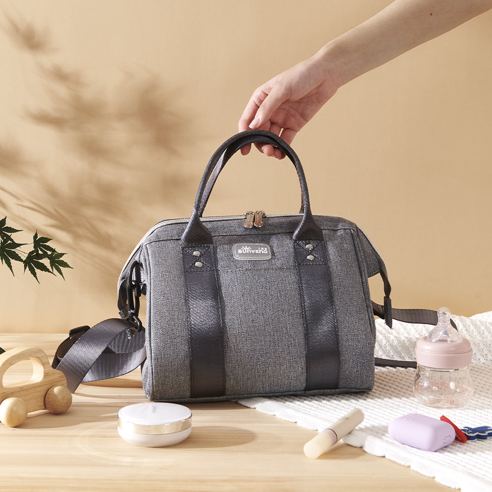 Small crossbody diaper bag in durable polyester with front pocket and bottle holders for modern parents — view 4