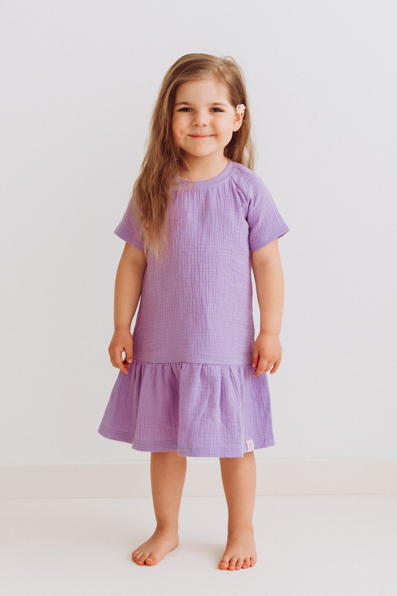 Minni girls dress with short sleeves and ruffled hem in lightweight cotton muslin fabric