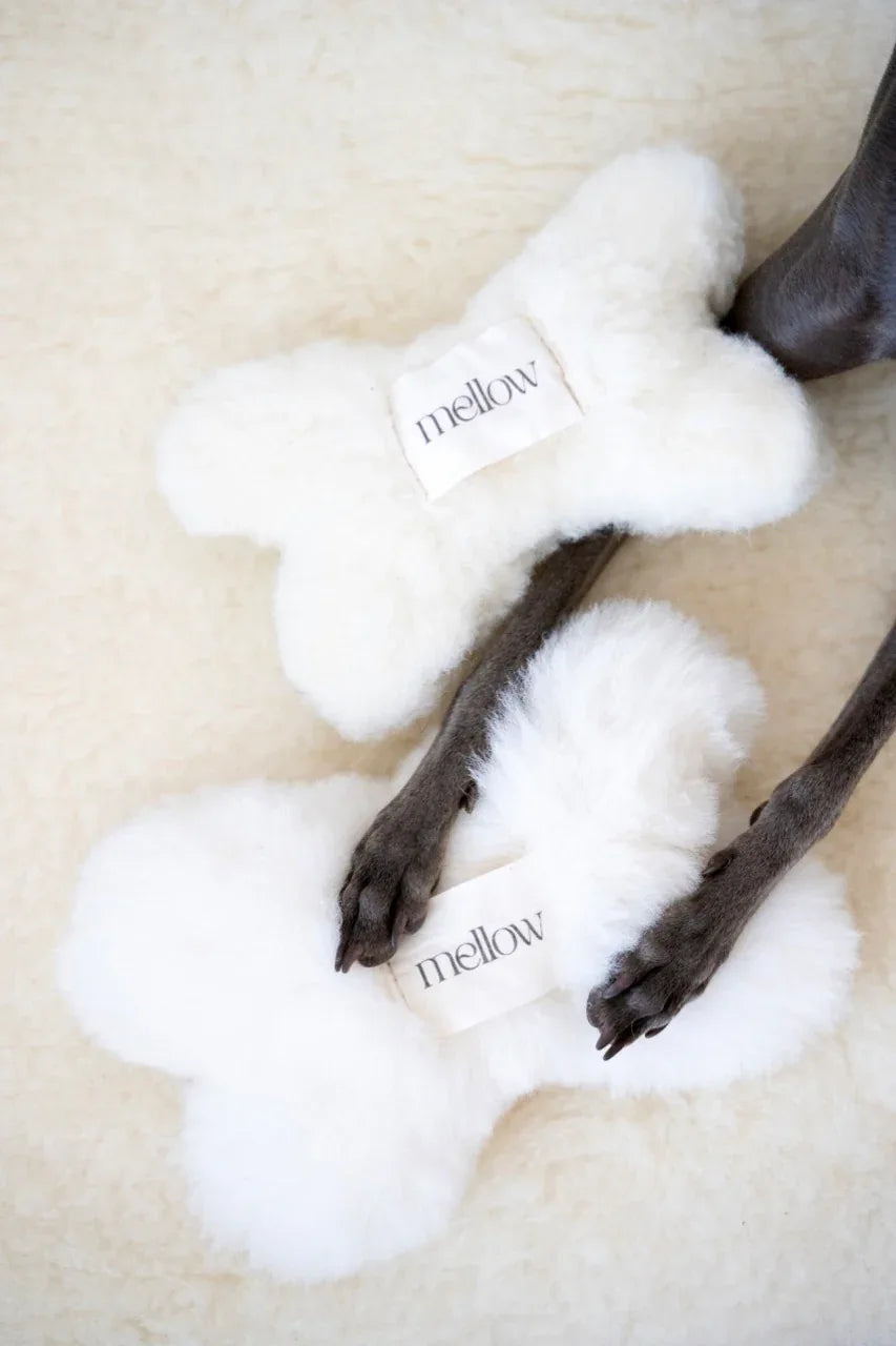 White natural sheepskin dog bone toy filled with eco friendly wool for safe pet play