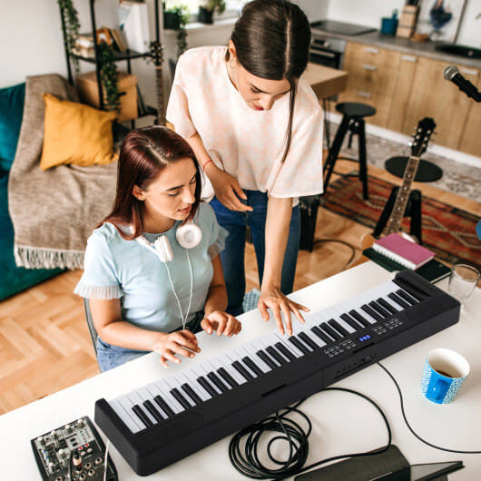 Pink 61-key foldable electronic piano keyboard with carrying bag and touch sensitive keys — view 2