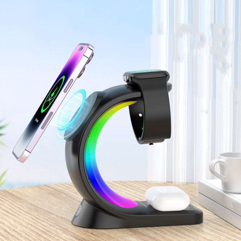 4-in-1 magnetic wireless charging station powering a smartphone, smartwatch, and earbuds with ambient light. — view 3