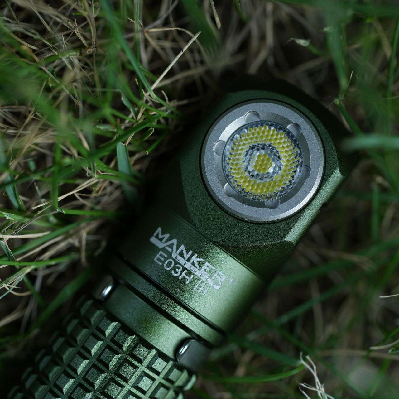 Black compact Manker E03H III flashlight and headlamp with elastic headband and attachable colored filters — view 5