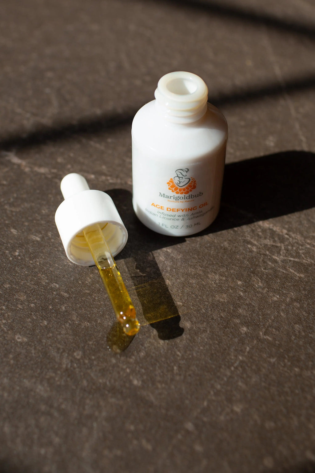 Age Defying Face Oil in a premium eco-friendly glass bottle with an easy application dropper. — view 2