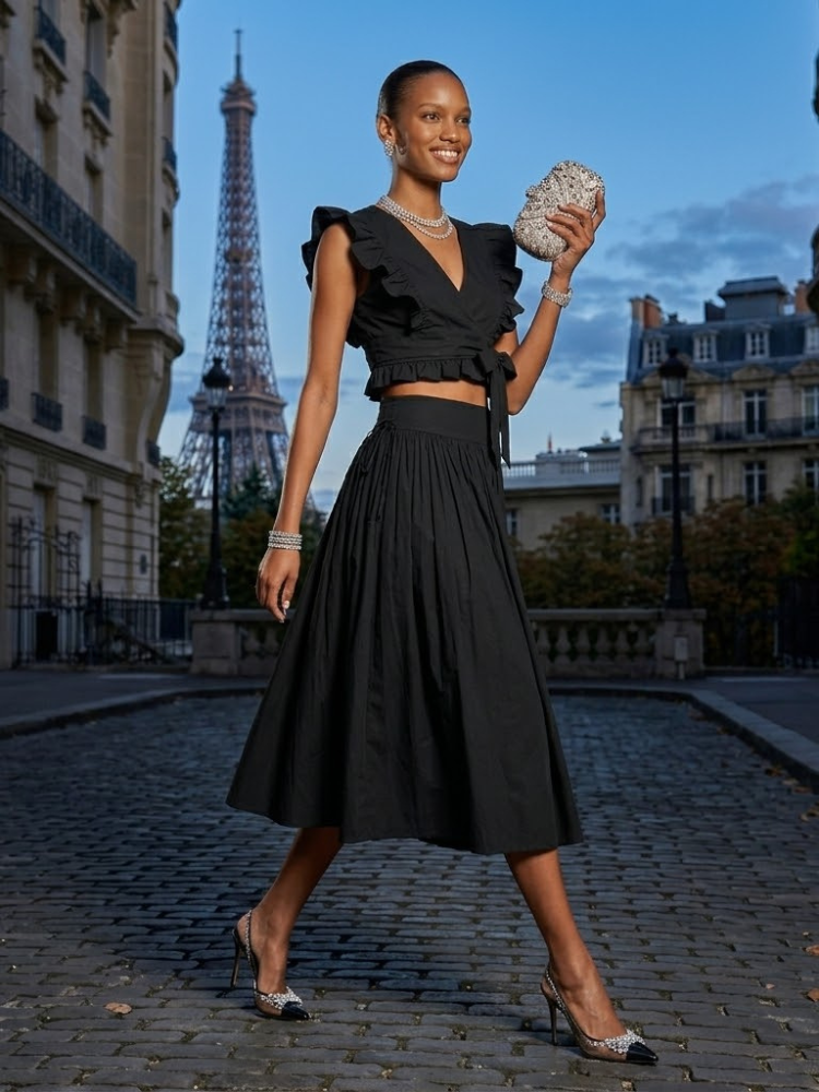 Black Saint-Germain matching set featuring a ruffle wrap top and high waisted pleated midi skirt