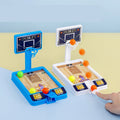 Mini desktop basketball game in blue and white plastic with three small orange balls