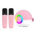 Pink mini karaoke machine speaker with two matching wireless microphones and vibrant LED lights