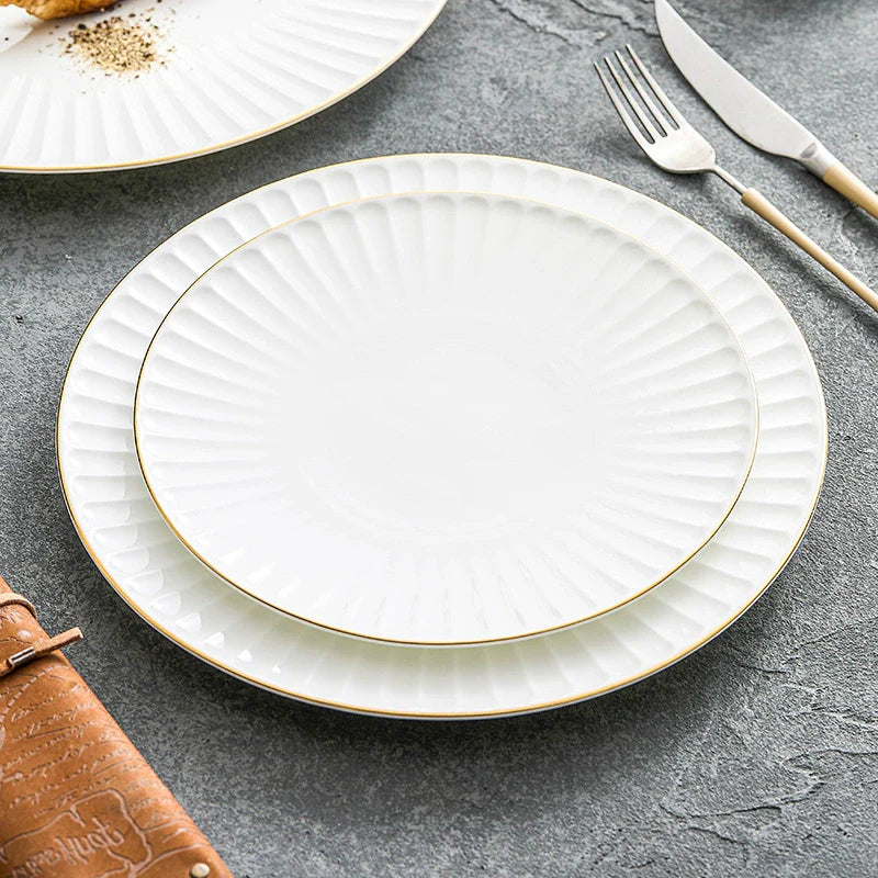 White ceramic dinner plate with pleated texture and a hand-painted gold rim — view 4