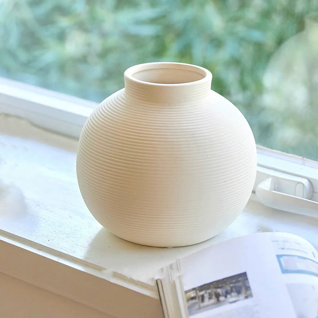 Minimalist ribbed ceramic vase in matte white, elegant unglazed textured centerpiece for modern home decor