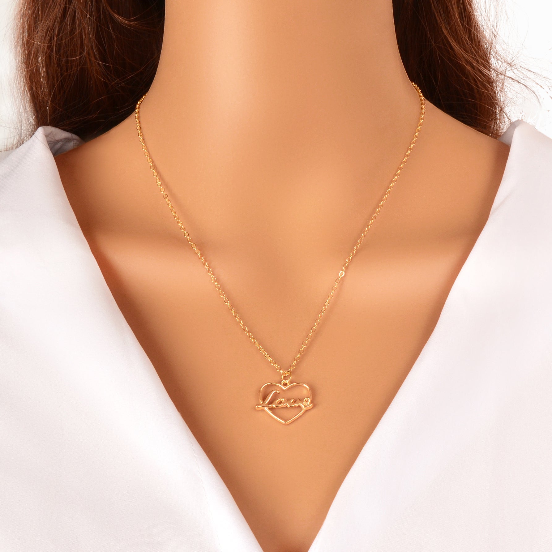 Gold-tone LOVE letter pendant necklace with a delicate heart motif on a classic link chain