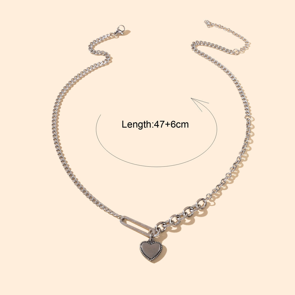 Layered multiple silver chain necklace featuring a polished love heart charm pendant on a display — view 4