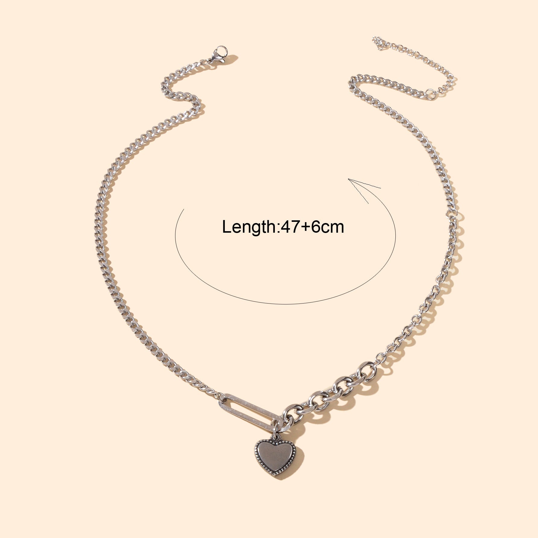 Layered multiple silver chain necklace featuring a polished love heart charm pendant on a display — view 4