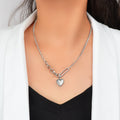 Layered multiple silver chain necklace featuring a polished love heart charm pendant on a display