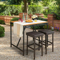 Two brown rattan patio bar stools with steel frames and built in footrests for outdoor dining