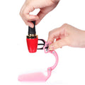 Pink nail polish fixation clip holding a bottle for a mess-free manicure experience