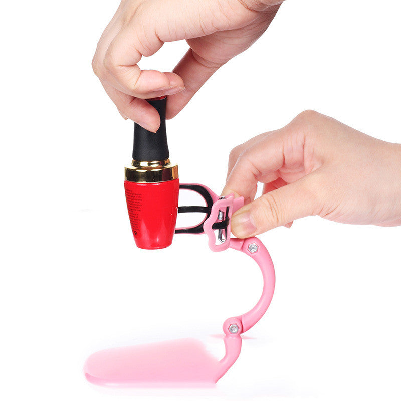 Pink nail polish fixation clip holding a bottle for a mess-free manicure experience