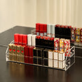 Clear acrylic nail polish organizer stand holding cosmetic bottles on a vanity table