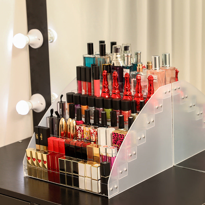 Clear acrylic nail polish organizer stand holding cosmetic bottles on a vanity table — view 2